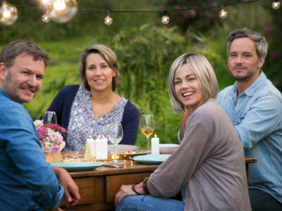 A summer evening of friends in their 40s gather around a table i A summer evening of friends in their 40s gather around a table i